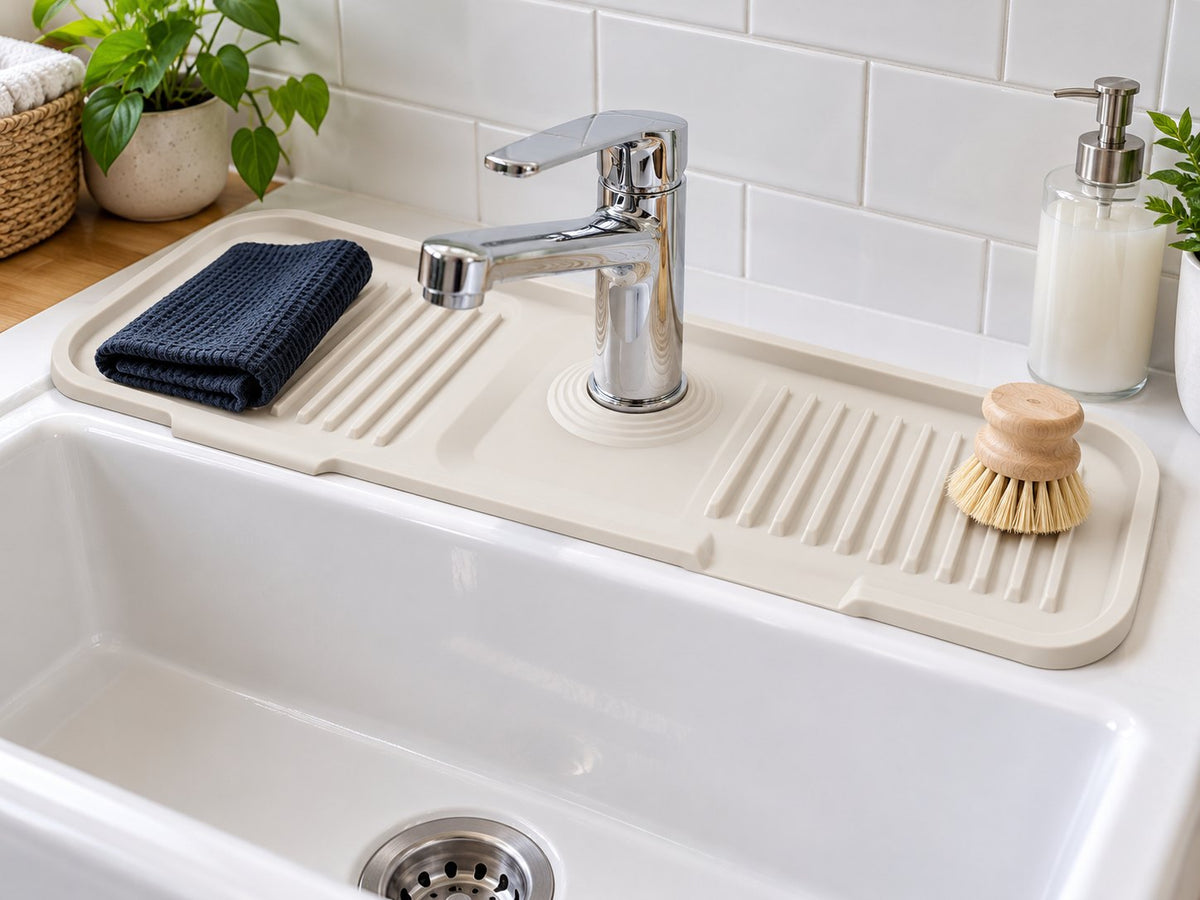An orderly sink area with faucet mat and a small set of essentials