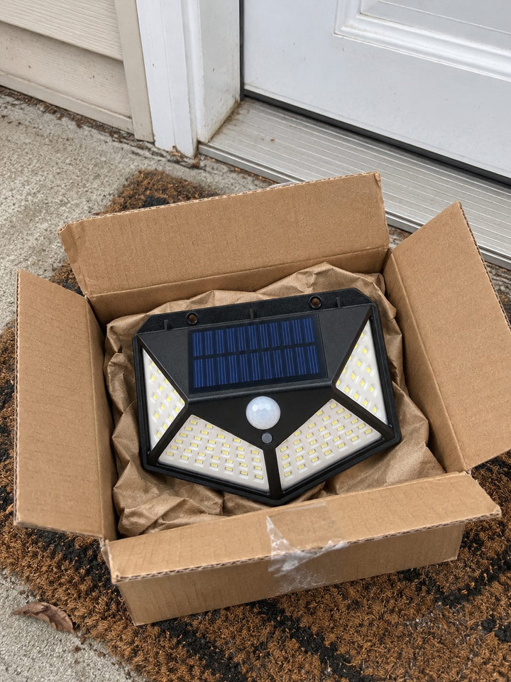 Boxed solar light on a front-door doormat