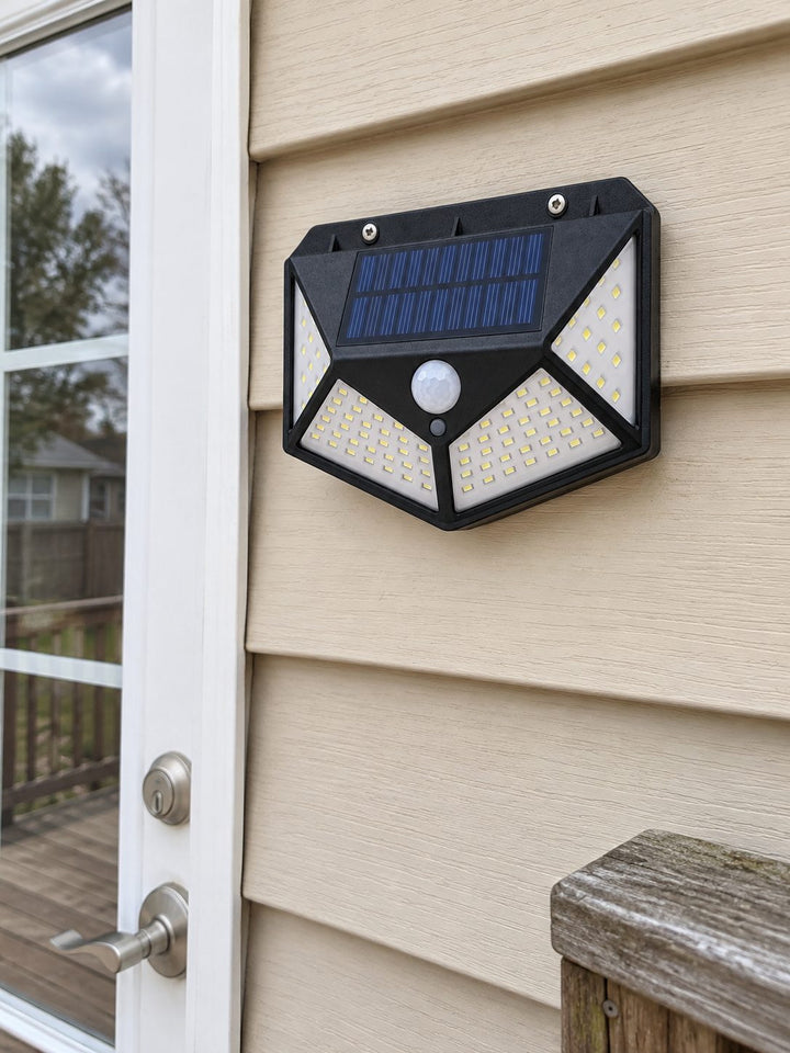 Solar light mounted on siding beside a patio door