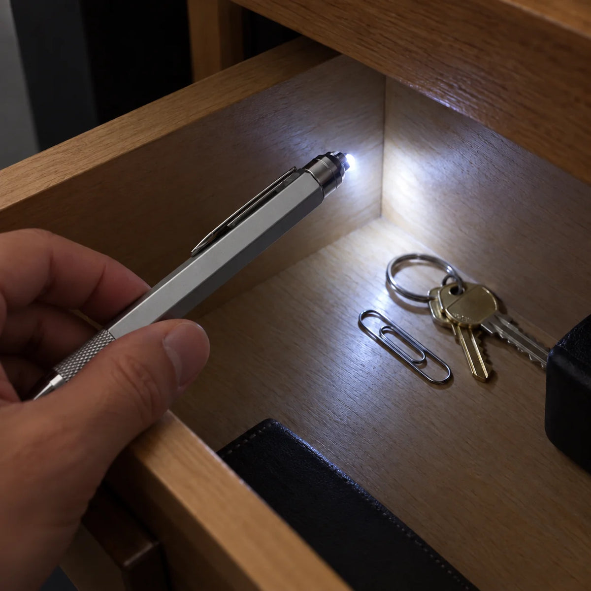 Built-in multitool pen LED illuminating a nearby dim area